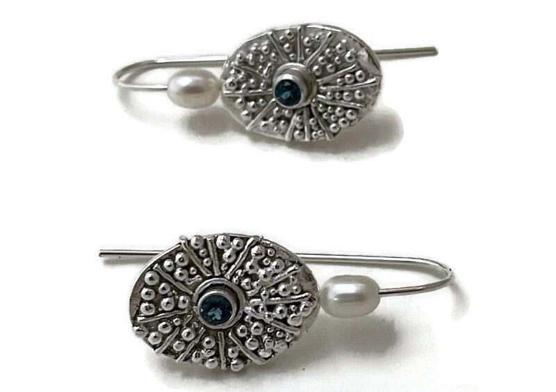 These earrings are very tactile because they feature tiny fine silver balls with silky white pearls and blue topaz.  One-of-a-kind.  They feel good to the fingers and are also visually interesting to whomever sees them.