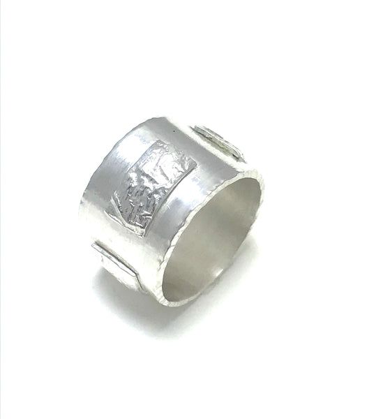 Thick Sterling silver band with rectangular textured recticulated silver accents.