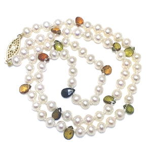 Silky smooth white pearls with fall colored tourmalines.  