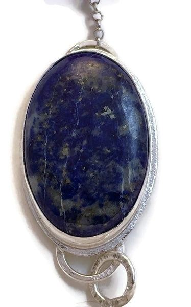 Close up photo of just the lapus lazuli showing the white and gold veining.