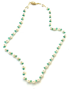 A beautiful pearl knotted necklace of just white akoya pearls and green emeralds.  There is a 14KY safety clasp and 20KY accent beads at the clasp for secure holding.  17 1/2" Length.