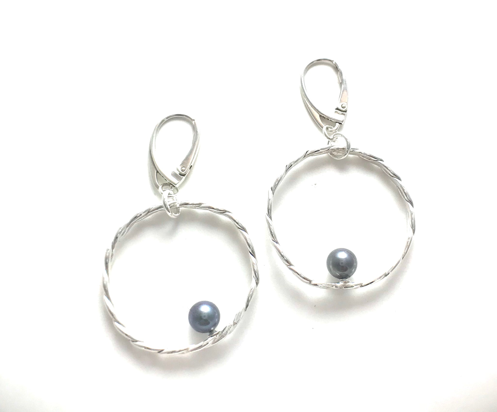 Braided silver with silky gray pearl accents.   These earrings hang on Leverbacks.