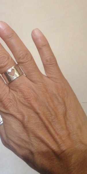 A photo of the heart ring on a customer's hands.   