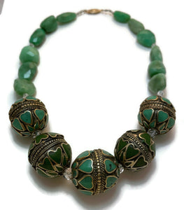 A beautiful necklace of chunky green chrysacolla-in-chalcedony beads in varying sizes accented with sterling silver and heart shaped turquoise inlaid beads from Turkmenistan.   The beads are very tactile.   Gold filled safety clasp. 17 1/2" in length.   One-of-a-kind.